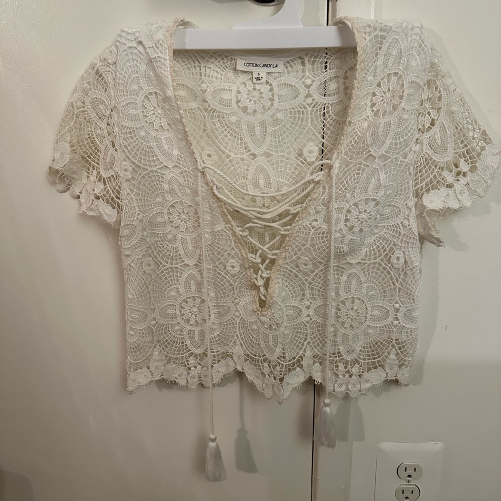 Cute lace crop top with front tie. Lined in front, but not in back. Fairly worn